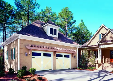 Carriage Court Kensington garage door in Almond on a home