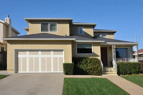 Carriage Court Pinetop garage door in Wicker Tan on a home