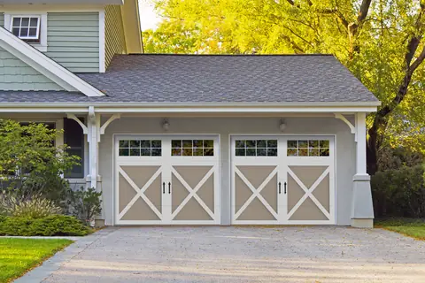 Carriage Court Rosemont garage door in Sandtone on a home