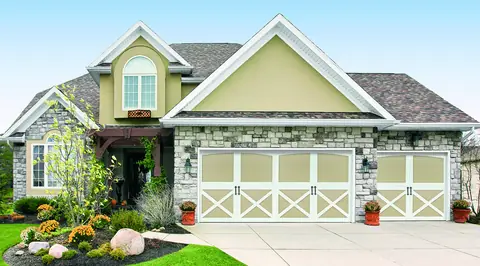 Carriage Court Tanglewood garage door in Wicker Tan on a home