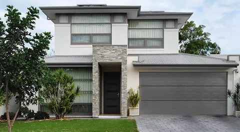 Classica Flush garage door in Charcoal Gray on a home