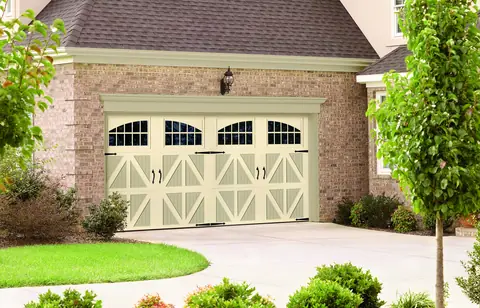 Classica Valencia garage door in Almond / Wicker Tan on a home