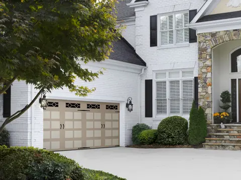 Heritage Bead Board garage door in Custom Paint Beige on a home