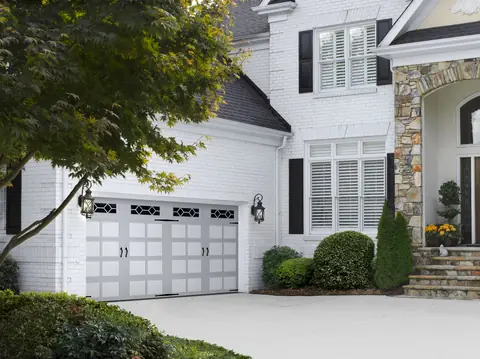 Heritage Bead Board garage door in Custom Paint Gray on a home