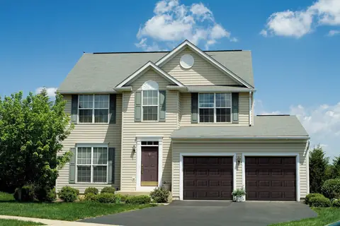 Heritage Short Panel garage door in Mahogany on a home