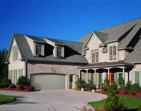 Olympus Long Panel garage door in Sandtone on a home